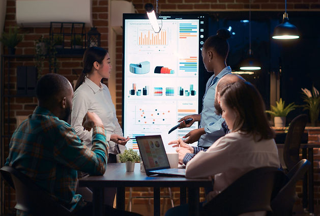 A group of employees discussing data represented by charts.